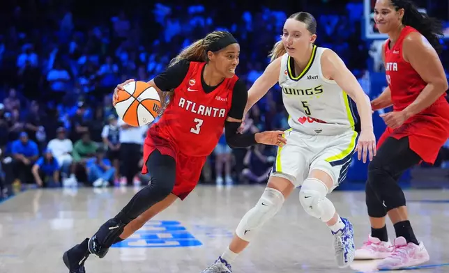 Atlanta Dream guard Jordin Canada (3) dribbles against Dallas Wings guard Paige Bueckers (5) during the second half of a WNBA basketball game in Arlington, Texas, Wednesday, July 29, 2026. (AP Photo/LM Otero)