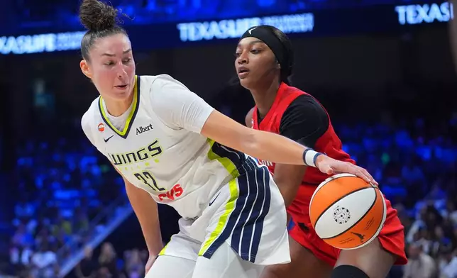 Dallas Wings forward Jessica Shepard (32) moves the ball against Atlanta Dream forward Angel Reese during the first half of a WNBA basketball game in Arlington, Texas, Wednesday, July 29, 2026. (AP Photo/LM Otero)