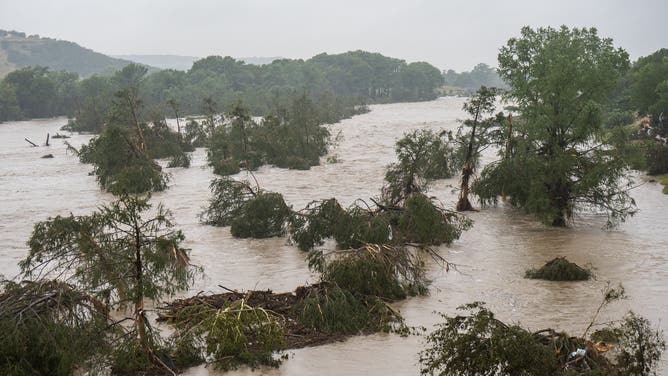 Trees emerge from flood waters along the Guadalupe River on July 4, 2025 in Kerrville, Texas.