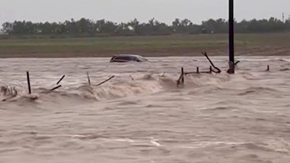 A vehicle is swept away in floodwater in Uvalde County, Texas, on July 14, 2026.