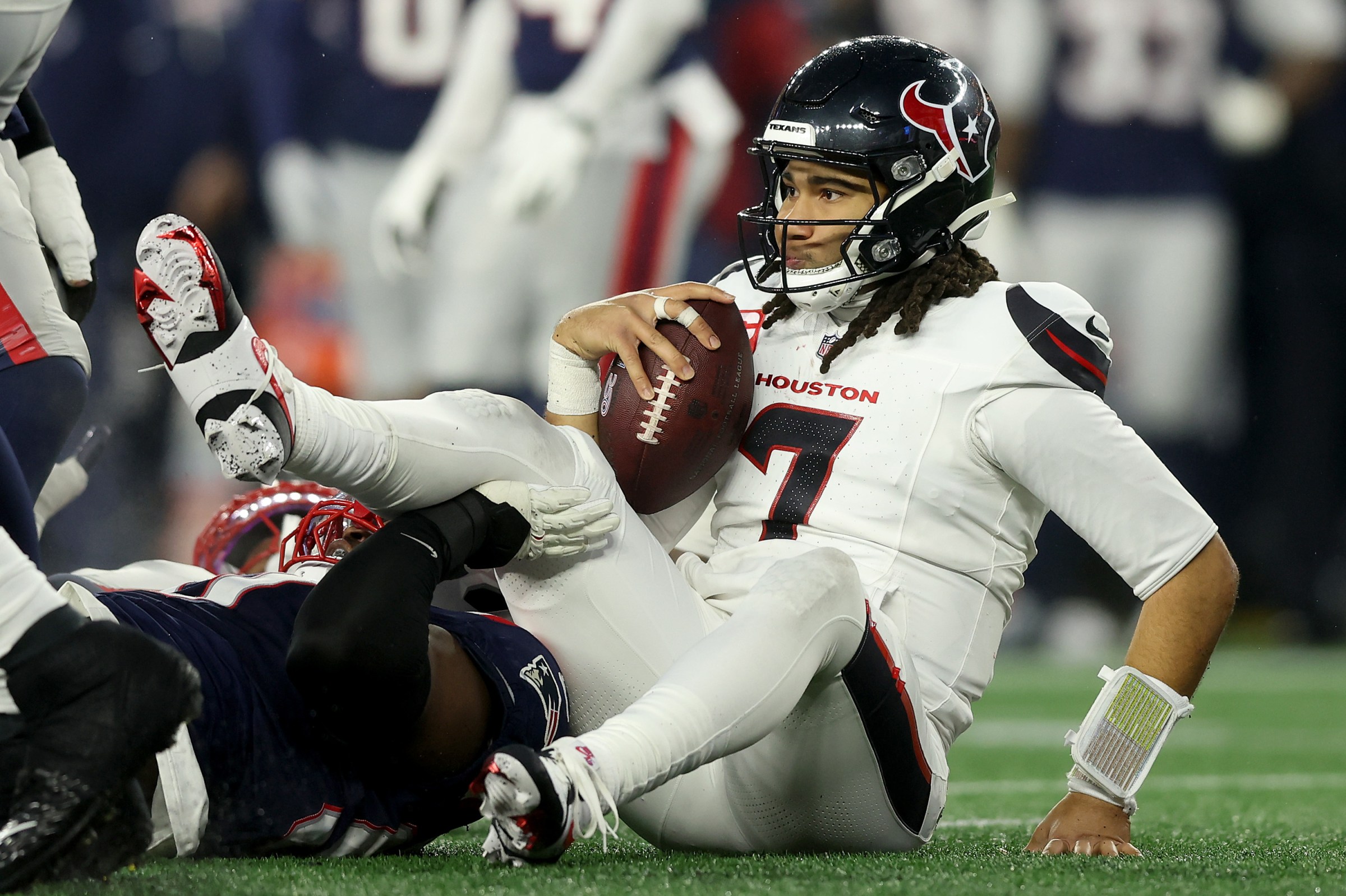 FOXBOROUGH, MASSACHUSETTS - JANUARY 18: C.J. Stroud #7 of the Houston Texans reacts after a run against the New England Patriots during the second quarter in the AFC Divisional Playoff game at Gillette Stadium on January 18, 2026 in Foxborough, Massachusetts. (Photo by Adam Glanzman/Getty Images)