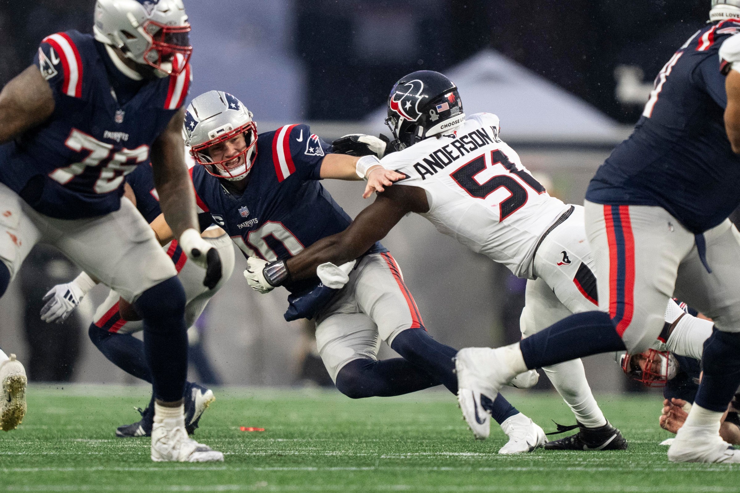 FOXBOROUGH, MASSACHUSETTS - JANUARY 18: Drake Maye #10 of the New England Patriots is sacked by Will Anderson Jr. #51 of the Houston Texans during an NFC Divisional Playoff game at Gillette Stadium on January 18, 2026 in Foxborough, Massachusetts. (Photo by Michael Owens/Getty Images)