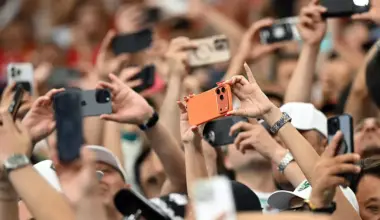 Spectators take photos with their smartphones during a World Cup match at the Houston Stadium in Houston on June 23. The Supreme Court is allowing Texas to enforce a law that limits minors' access to app stores on mobile devices while lawsuits continue in the lower courts.