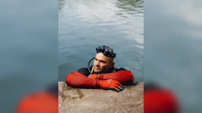 INGRAM, TEXAS - JULY 1: Ryan Logue, an amateur diver who has dedicated himself to finding remains of the July 4 flood victims along the Guadalupe River, poses for a portrait at Ingram Lake in Ingram, Texas, US, on Wednesday, July 1, 2026.