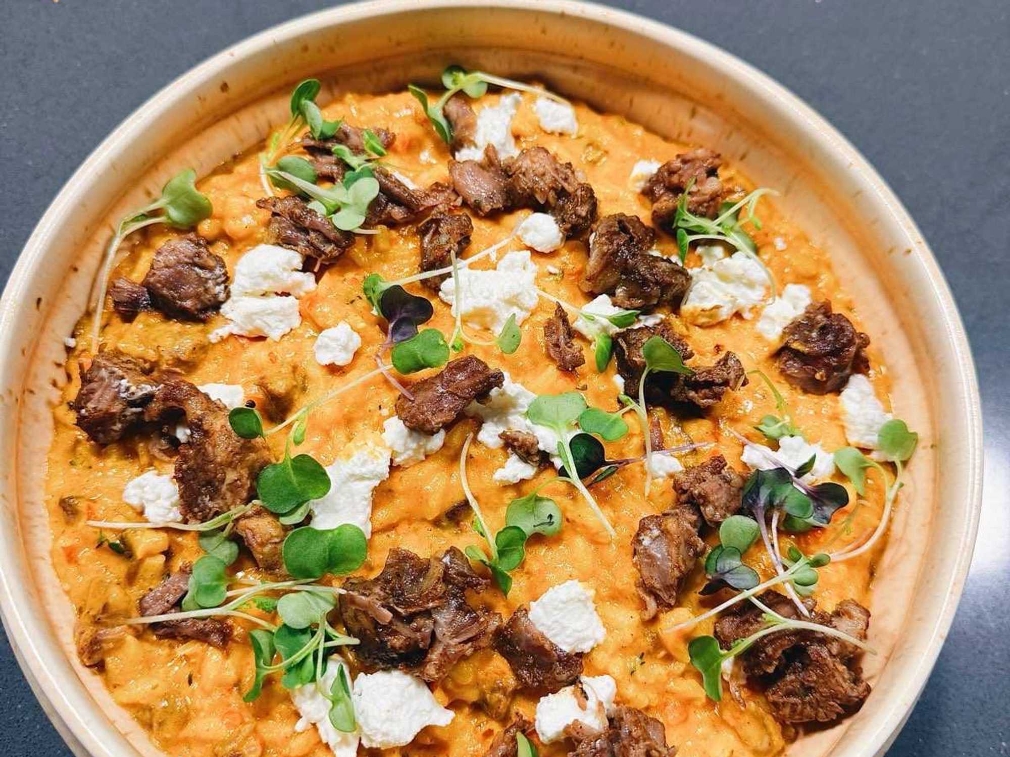Jollof Risotto with braised oxtail and creamy goat cheese, another innovative dish from the Ebi-Ayo Supper Club menu.