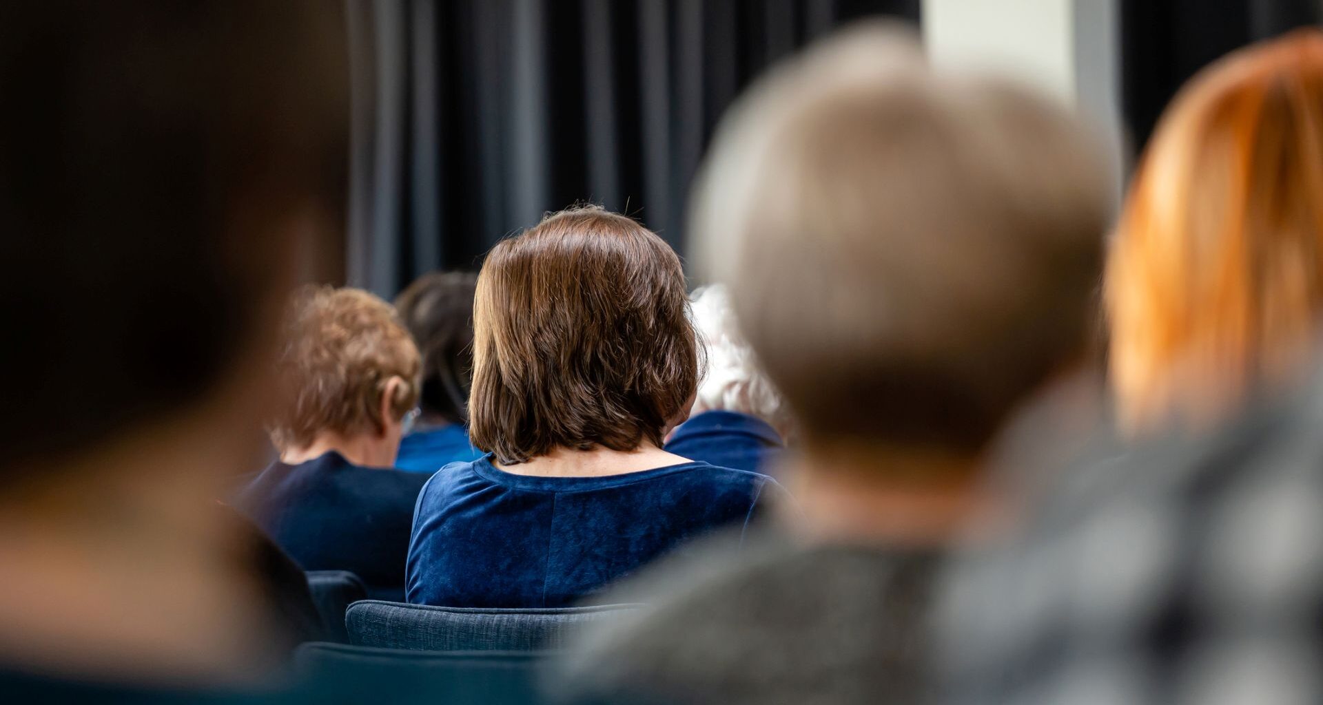 A group of people sitting in a meeting.