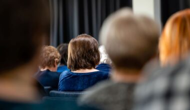 A group of people sitting in a meeting.