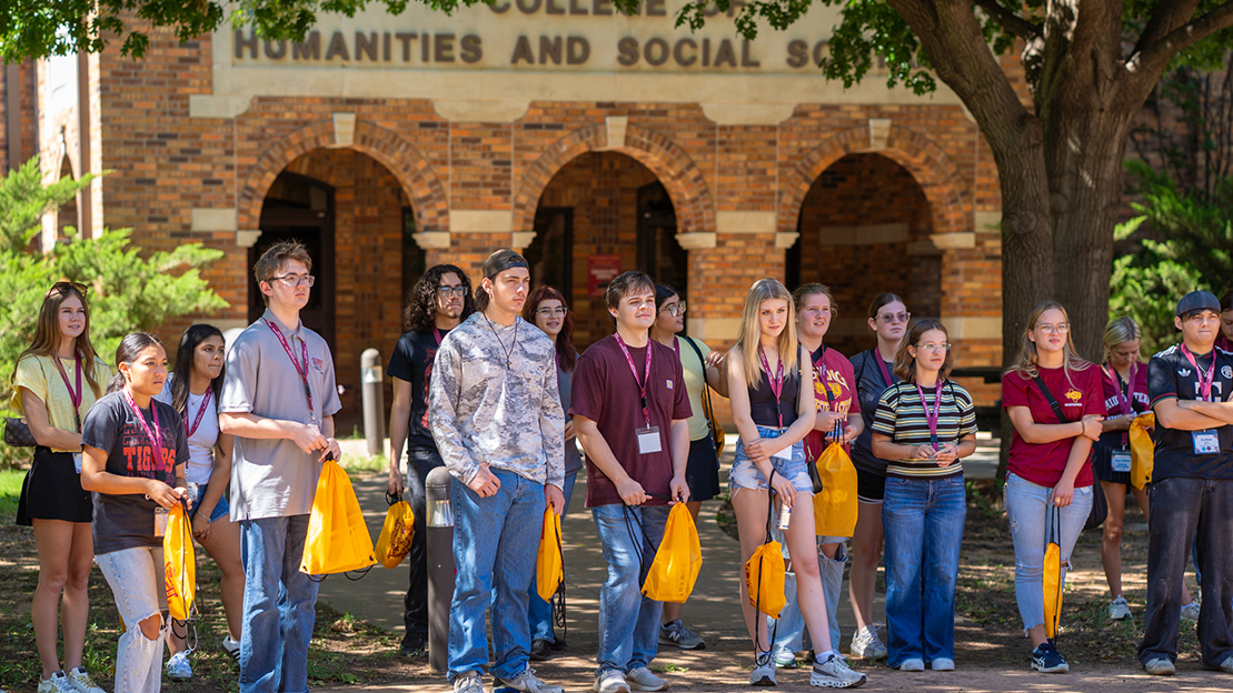 Large group of students stand in front of the Prothro-Yeager College