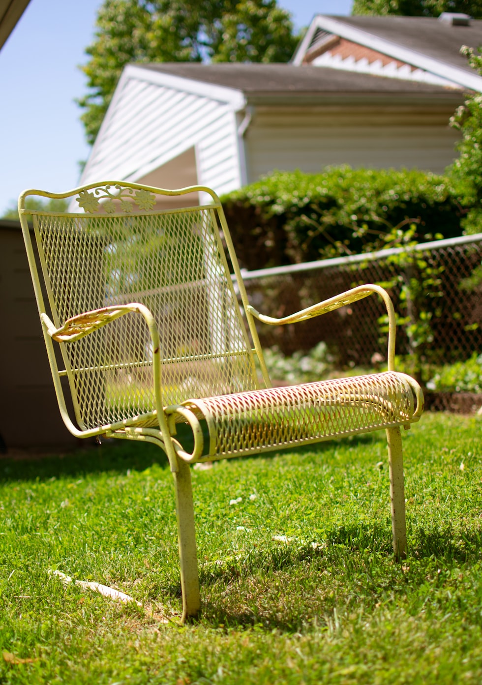 black metal armchair on green grass field during daytime