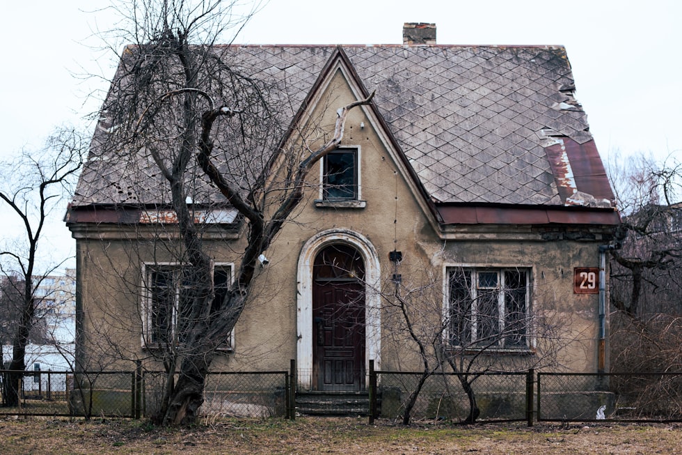 an old house with a fence around it