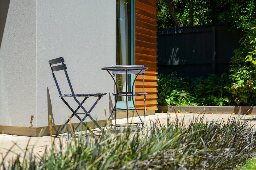 a couple of chairs sitting next to a table