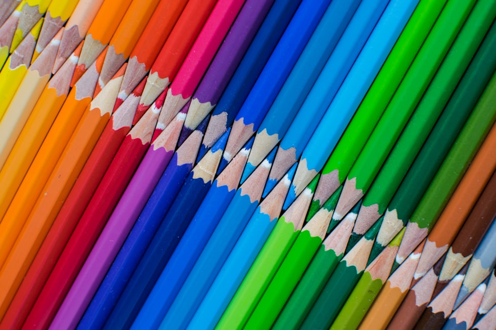 A row of colored pencils lined up in a row
