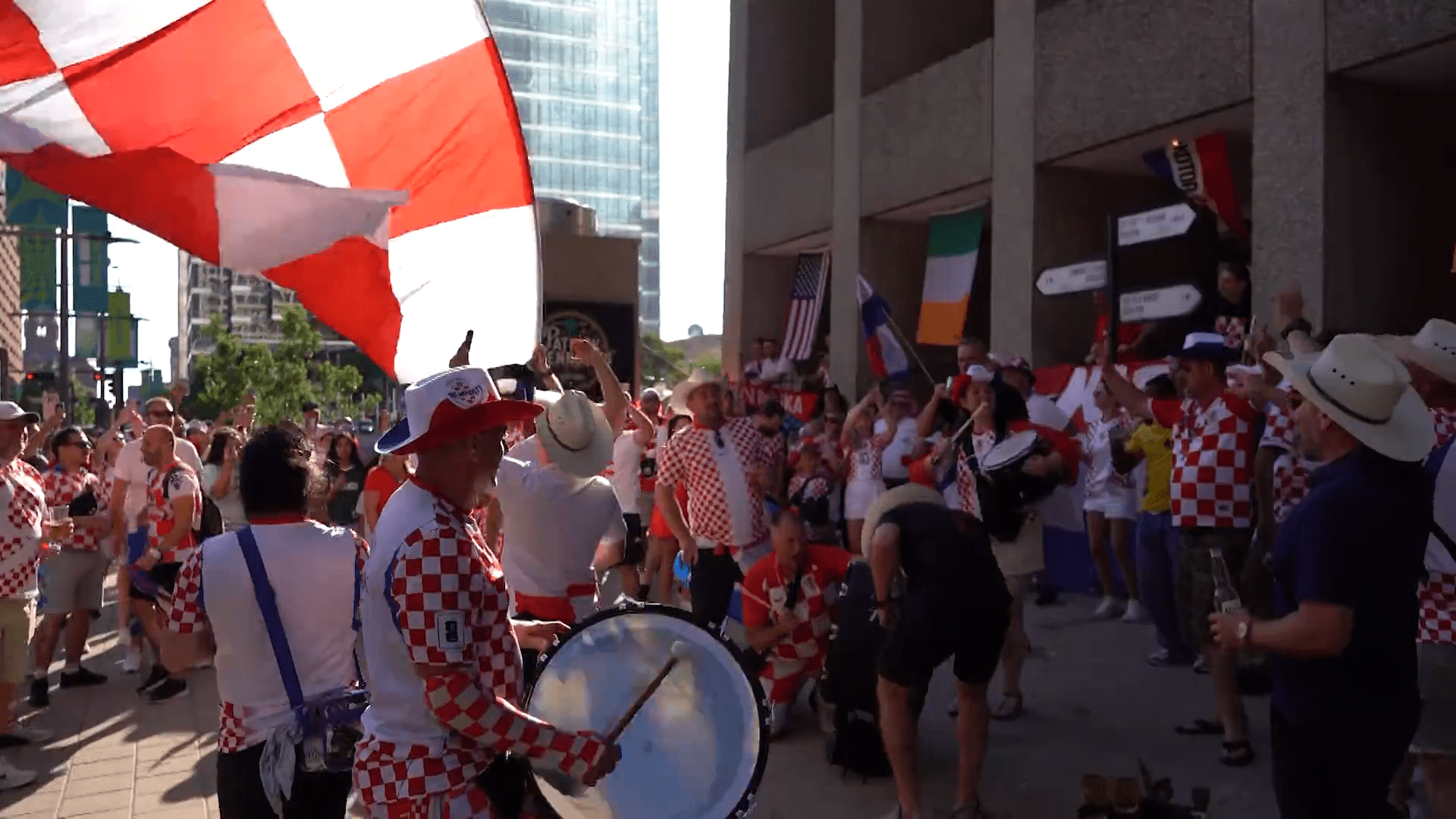 Croatia fans march through Downtown Dallas with a supporter flag. Fans celebrated with parties, parades, and plenty of team spirit. Croatia lost the game against England 4-2.