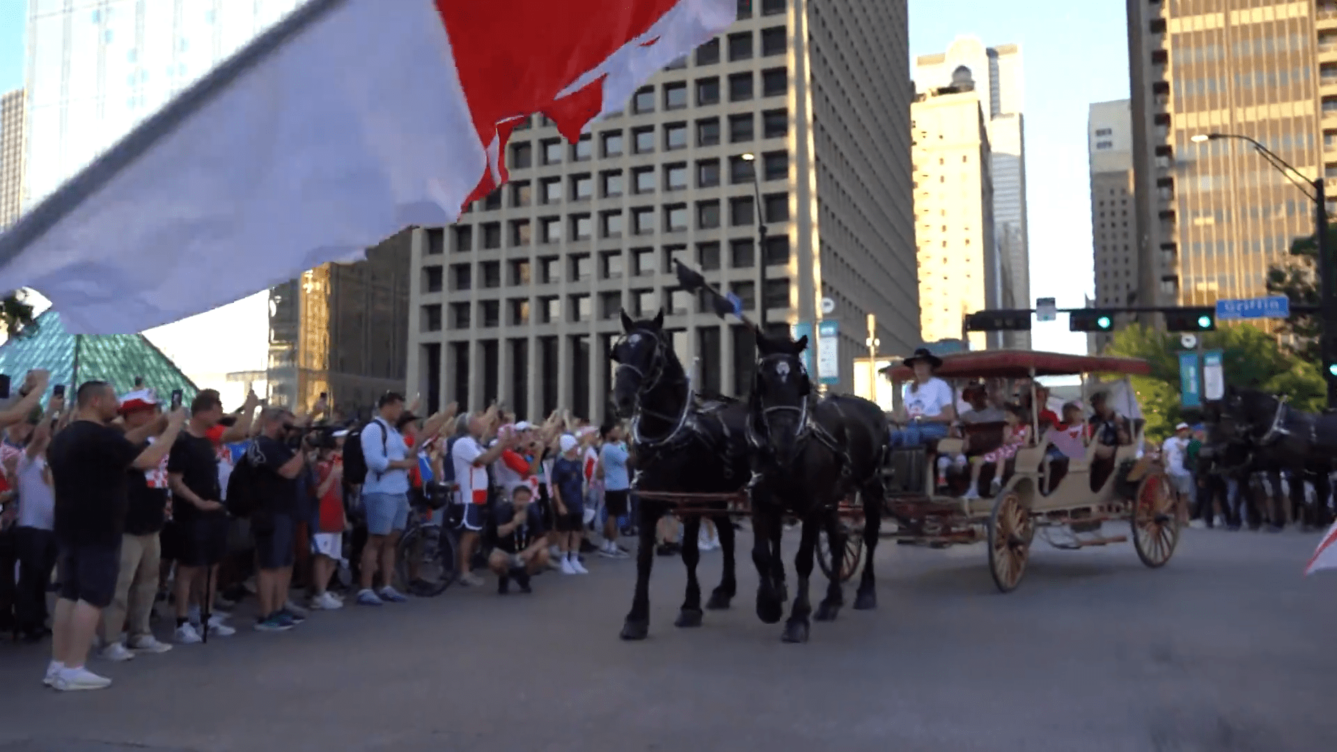 Croatia fans march along Griffin Street in Downtown Dallas with a supporter flag. Fans celebrated with parties, parades, and plenty of team spirit. Croatia lost the game against England 4-2.