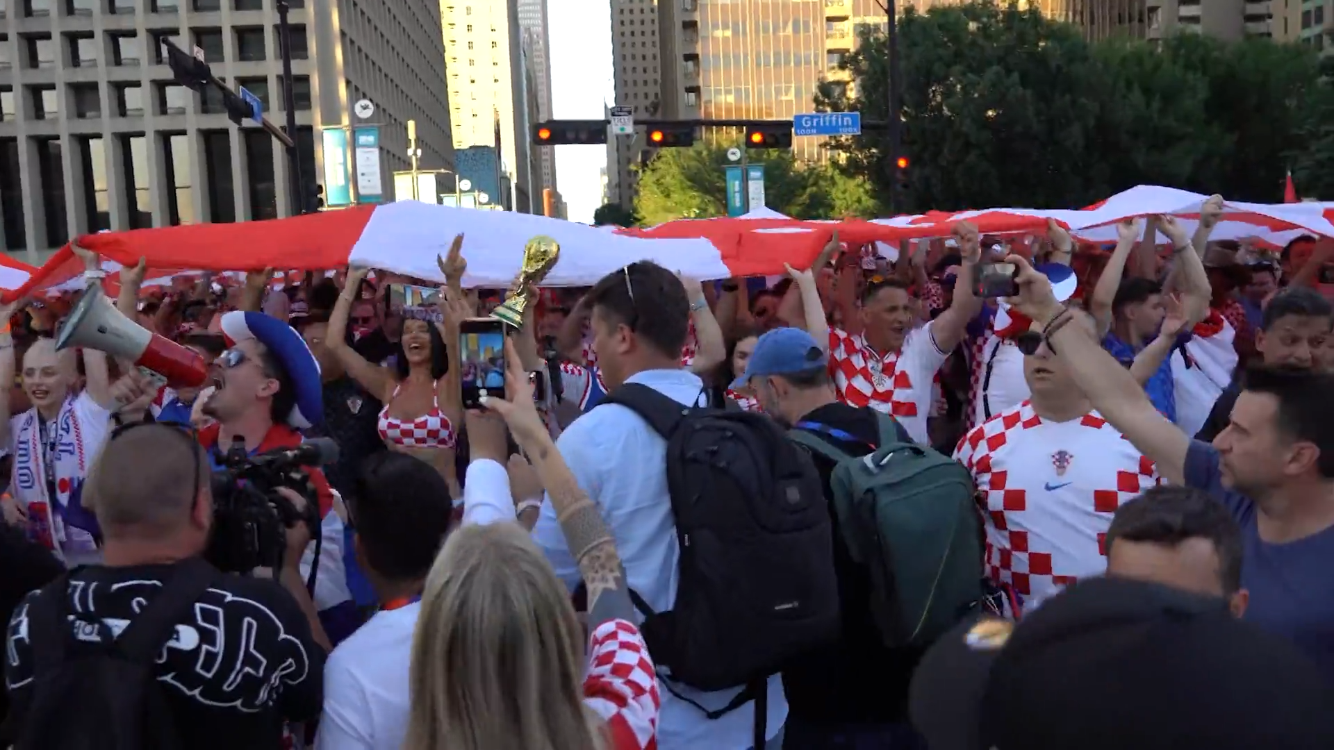 Croatia fans march along Griffin Street in Downtown Dallas with a supporter flag. Fans celebrated with parties, parades, and plenty of team spirit. Croatia lost the game against England 4-2.