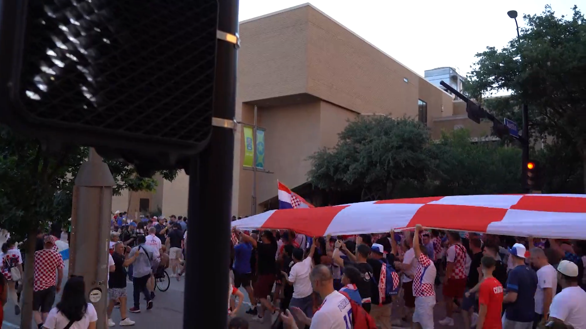 Croatia fans march in Downtown Dallas with a supporter flag. Fans celebrated with parties, parades, and plenty of team spirit. Croatia lost the game against England 4-2.