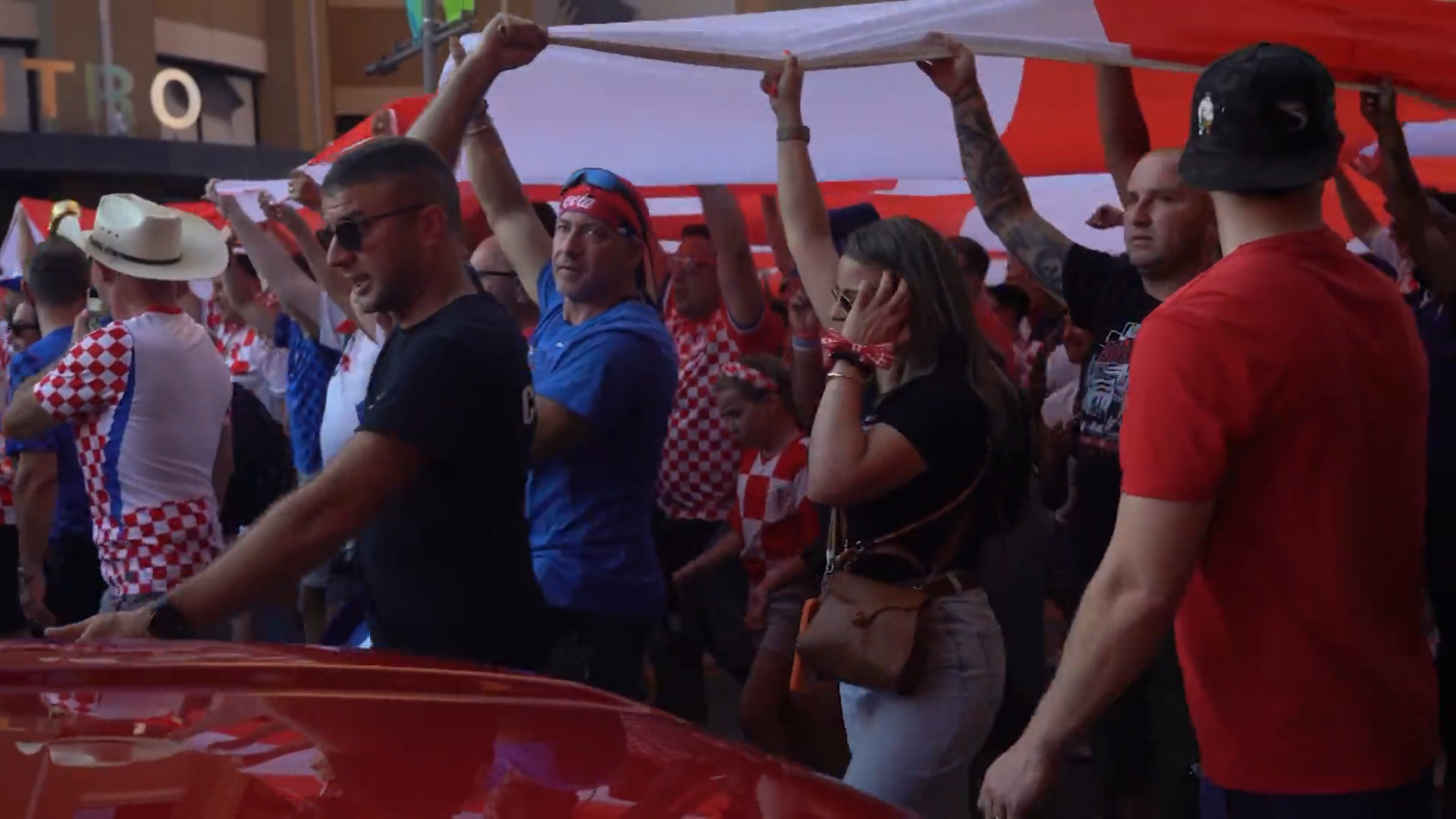 Croatia fans march in Downtown Dallas with a supporter flag. Fans celebrated with parties, parades, and plenty of team spirit. Croatia lost the game against England 4-2.