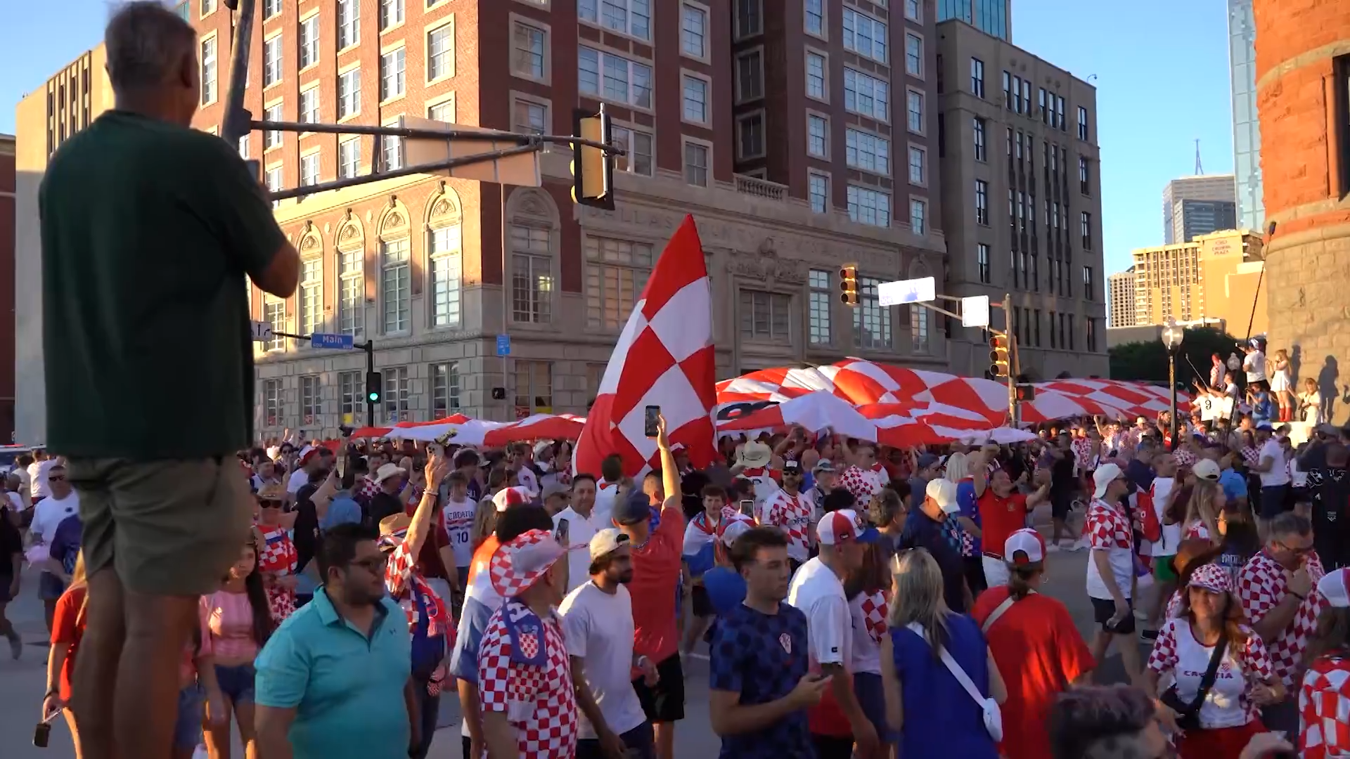 Croatia fans march in Downtown Dallas with a supporter flag. Fans celebrated with parties, parades, and plenty of team spirit. Croatia lost the game against England 4-2.