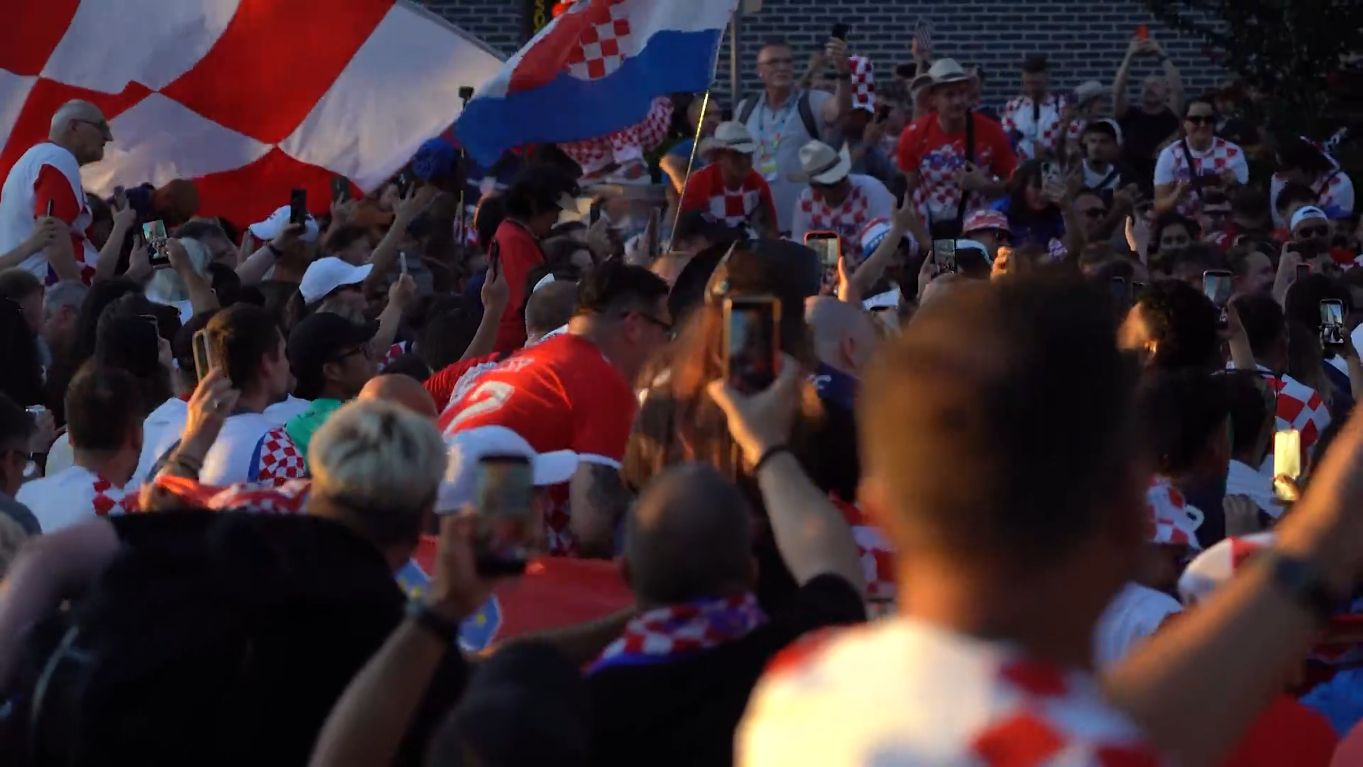 Croatia fans march in Downtown Dallas with a supporter flag. Fans celebrated with parties, parades, and plenty of team spirit. Croatia lost the game against England 4-2.