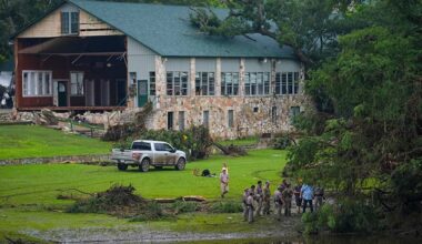 Officials search on the grounds of Camp Mystic along the banks of the Guadalupe River after a flash flood swept through the area Sunday, July 6, 2025, in Hunt, Texas. (AP Photo/Julio Cortez)
