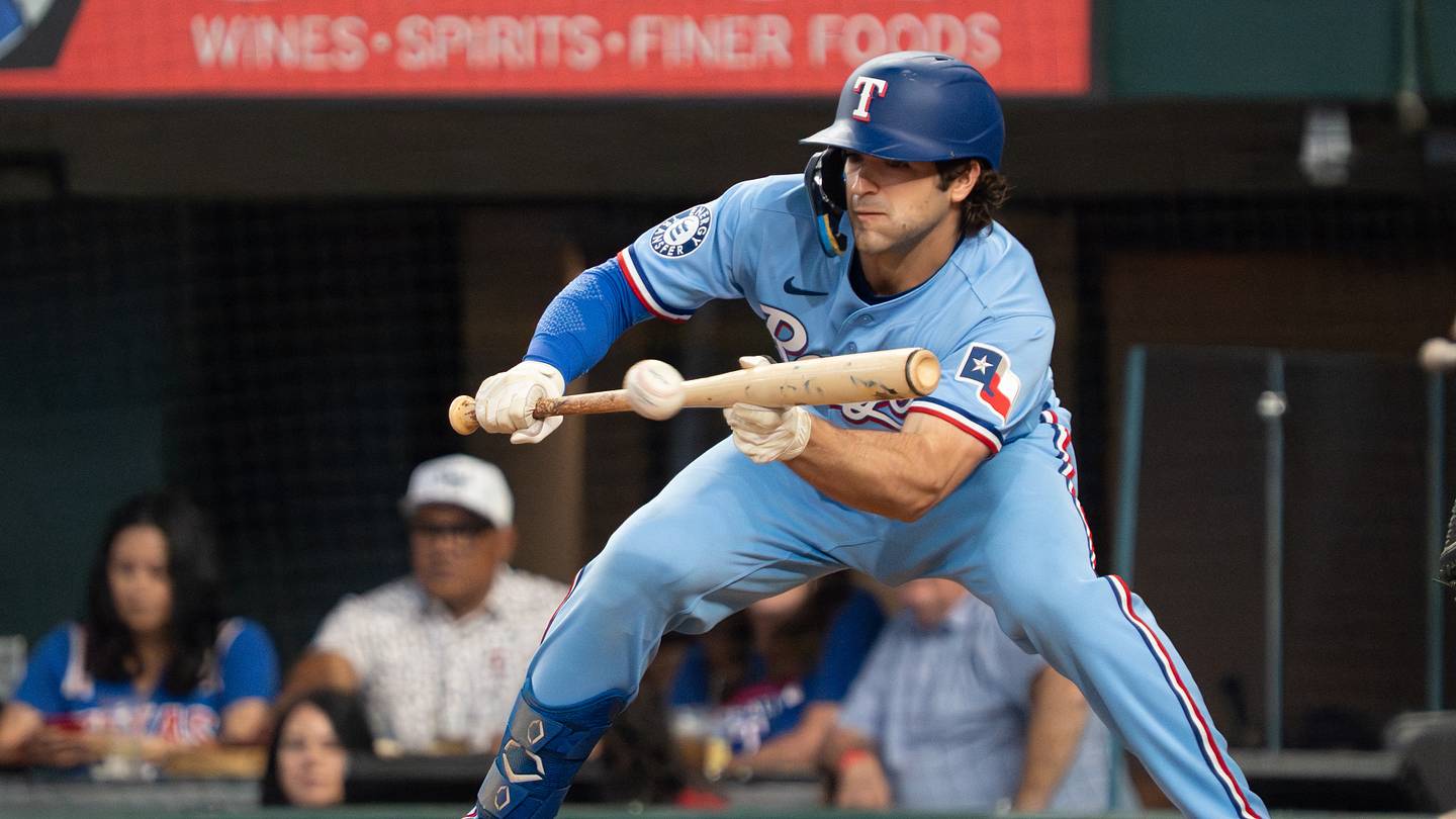 Apr 26, 2026; Arlington, Texas, USA;  Texas Rangers shortstop Josh Smith (8) lays down a bunt single during the sixth inning against the Athletics at Globe Life Field. Mandatory Credit: Raymond Carlin III-Imagn Images