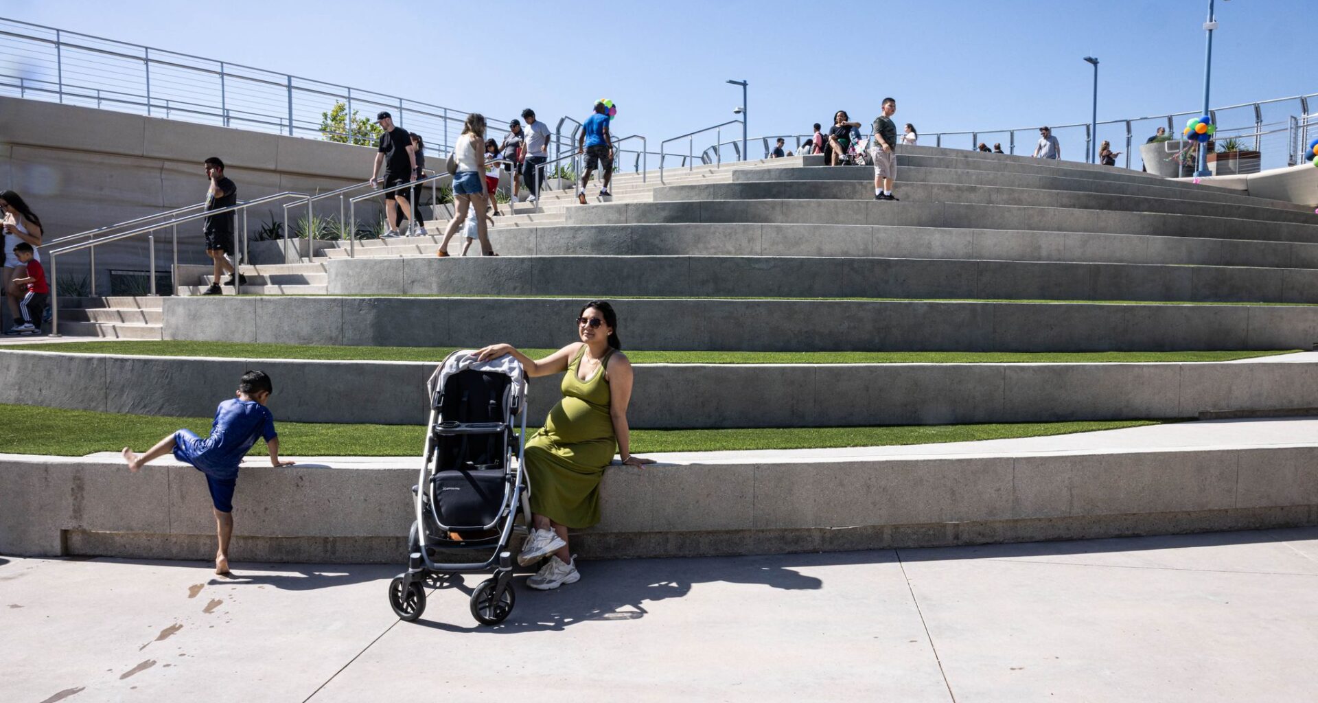 Lani Boudreaux, an Oak Cliff resident, sits on the amphitheater steps at Halperin Park for the opening celebration of Oak Cliff’s new deck park in Dallas, Saturday, May 9, 2026.