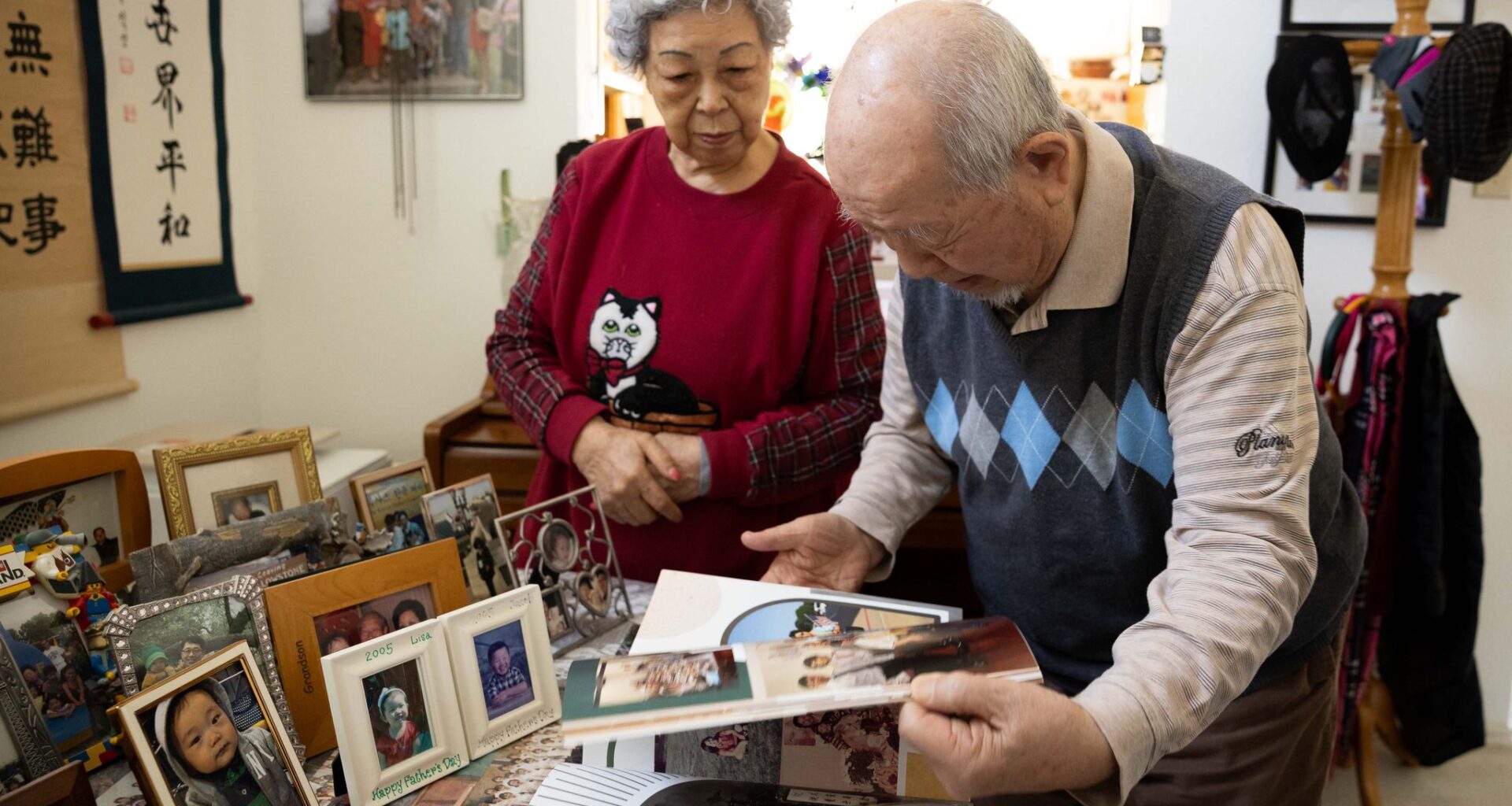 Charles Park, a Korean American community leader and elder, and Susie Aeja Park look through a photo book at their home in Garland, Friday, Jan. 30, 2026.