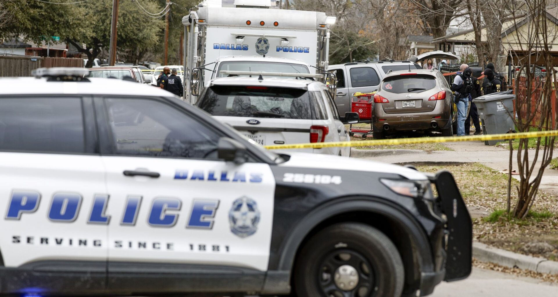 Dallas police work the scene of an officer-involved shooting near Shaw Street and North Winnetka Avenue, Friday, Feb. 20, 2026, in Dallas. Dallas police Chief Daniel Comeaux said police shot and killed a suspect Friday while serving a warrant.