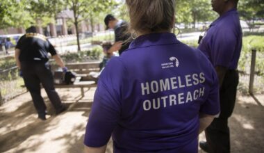 From left, Street outreach workers with Downtown Dallas, Inc. Leia Reneau and Charles Davis watch as paramedics speak to a men they discovered needed medical attention while talking to people at Civic Garden on Wednesday, May 15, 2024, in downtown Dallas.