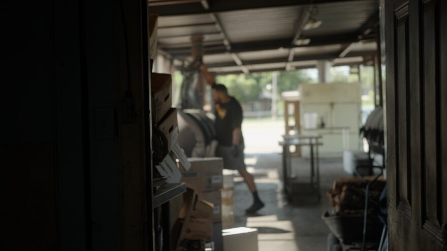 Goldee’s pitmaster Joseph Bastian opens a smoker as the team prepares briskets for another weekend of service.