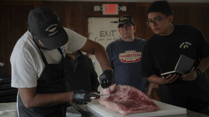 Goldee’s co-owner Zain Shafi demonstrates how to trim a brisket during one of the restaurant’s brisket classes. Shafi started his journey with Goldee’s as a student, before going out on his own and later returning to Goldee’s as an owner.
