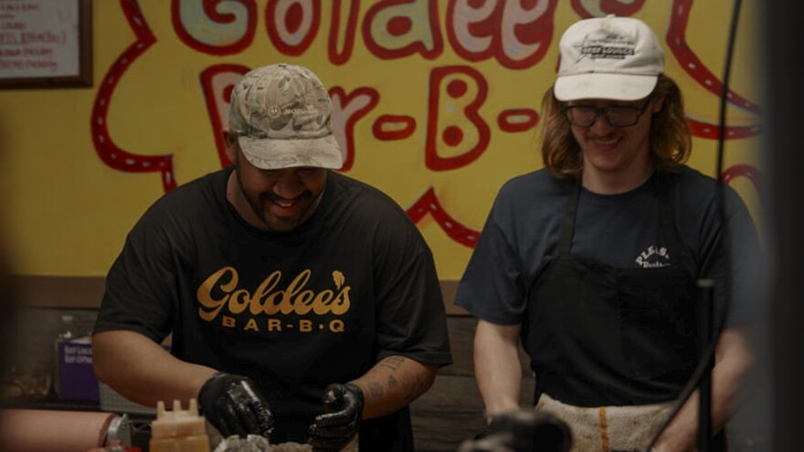 Goldee’spitmasters, Joseph Bastian and “Butch”, slice brisket for customers. Bothhave begundeveloping and testing recipes for restaurants they hope to open in the future.