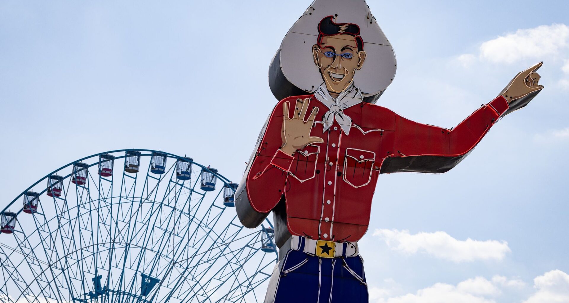 Big Tex near the ferris wheel on opening day of the Texas State Fair on Friday, Sept. 26, 2025, in Dallas.