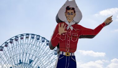 Big Tex near the ferris wheel on opening day of the Texas State Fair on Friday, Sept. 26, 2025, in Dallas.