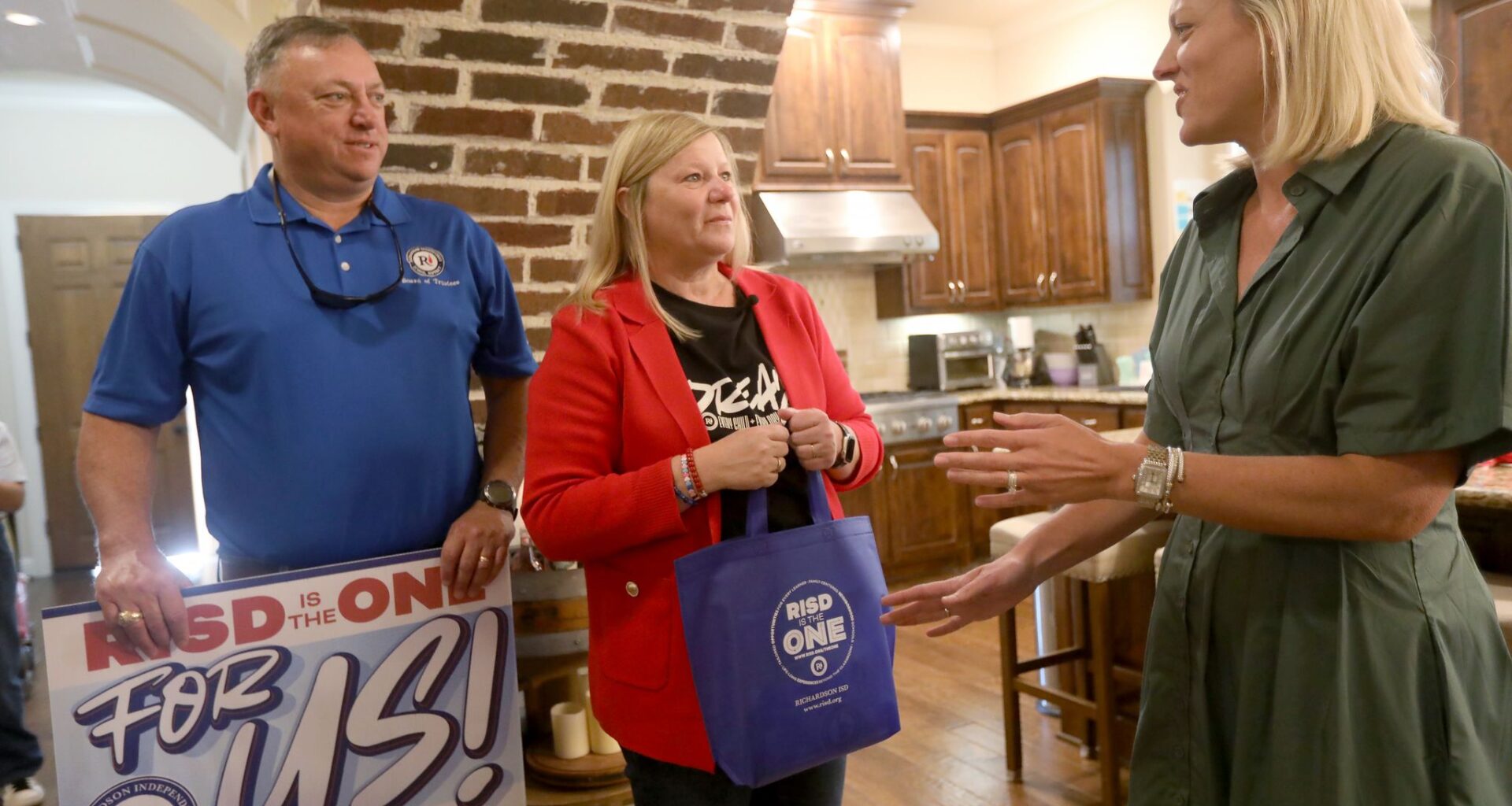 Richardson ISD Superintendent Tabitha Branum (center) and Chris Poteet, president of the Board of Trustees, talk to Becca Bass as they visited the homes of out-of-district students who are transferring into RISD, on Monday, Aug. 3, 2026.