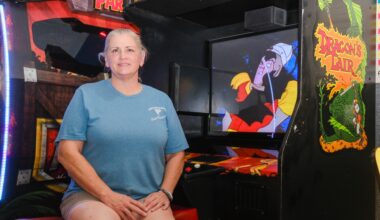 Tornado Terry’s owner Shannon Bell sits beside a custom Dragon’s Lair cabinet built by her late husband, Terry Bell, at the Fort Worth arcade Wednesday, Aug. 5, 2026. 