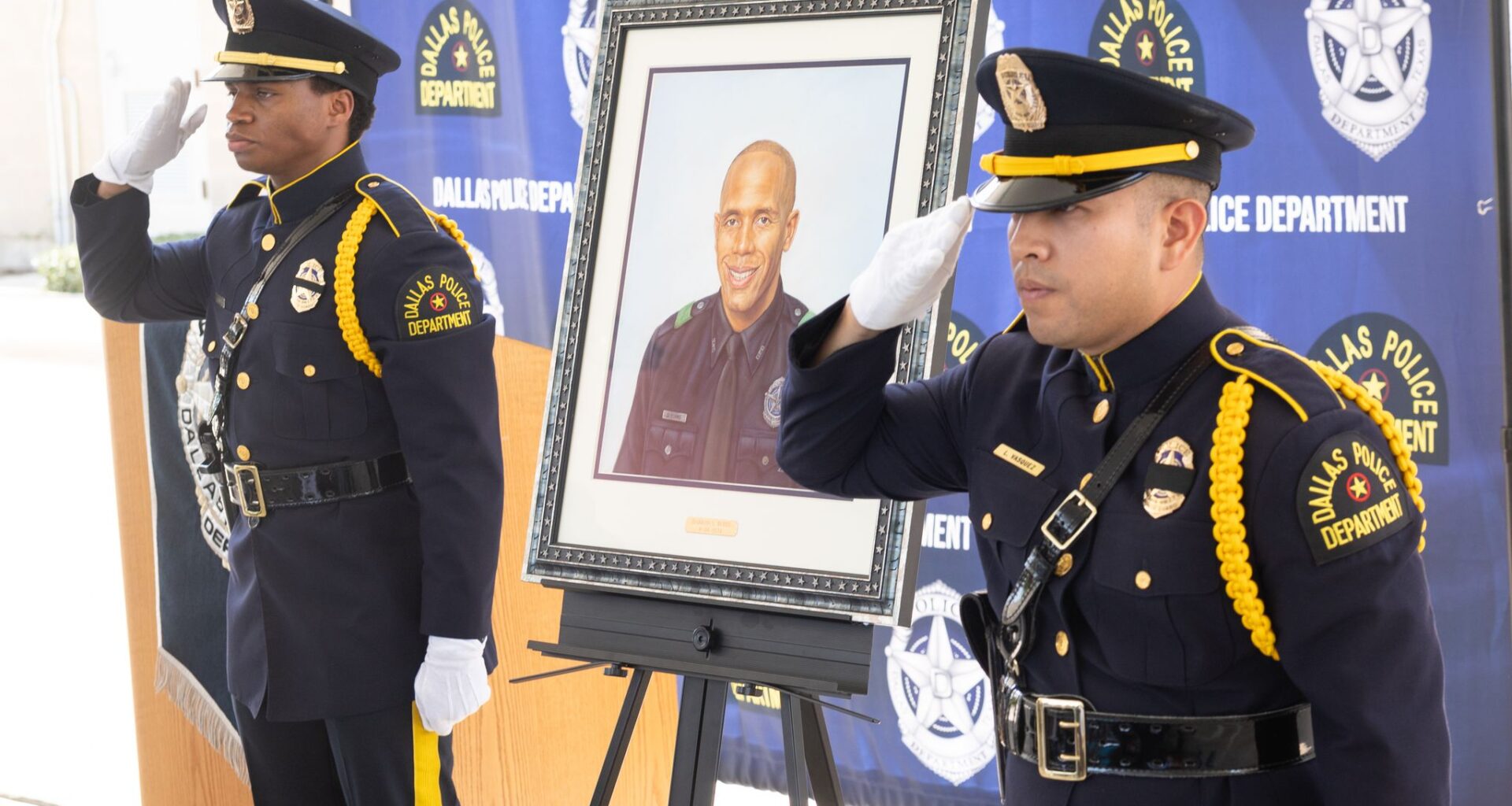 The Dallas police honor guard unveils a portrait honoring Dallas police Officer Burks, who was killed in 2024, during a ceremony at the South Central Division in Dallas, Friday, Aug. 7, 2026.