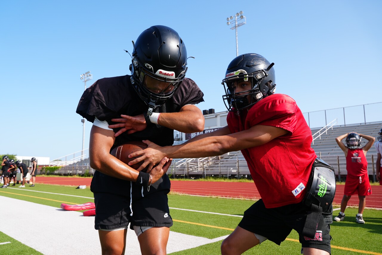 West Oso's Julio Acosta hands off to running back Kayden Dufour