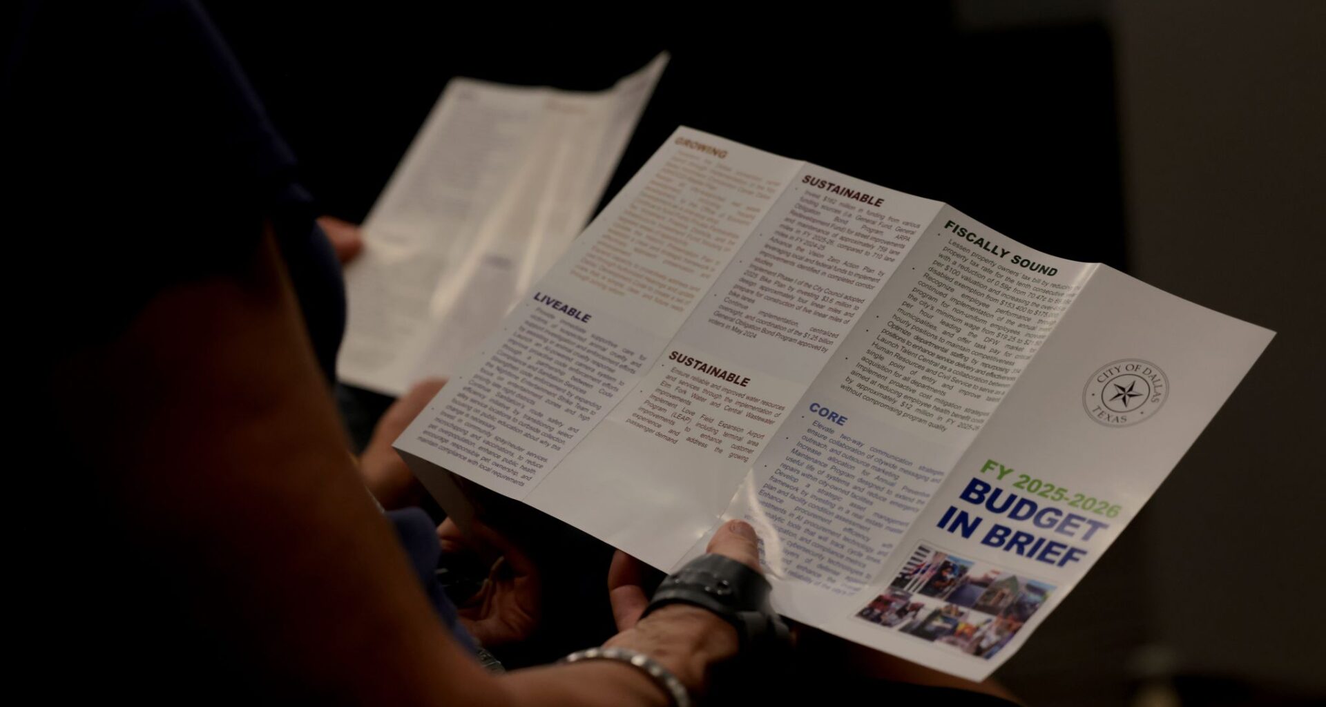 Residents peruse through printed material outlining the process of constructing the '26-27 City of Dallas budget which is estimated to be near $5 billion during a called meeting to increase awareness. The townhall meeting, sponsored and conducted by City of Dallas District 11 Council member Bill Roth, was held at Fretz Park Branch Library in Dallas on March 26, 2026.