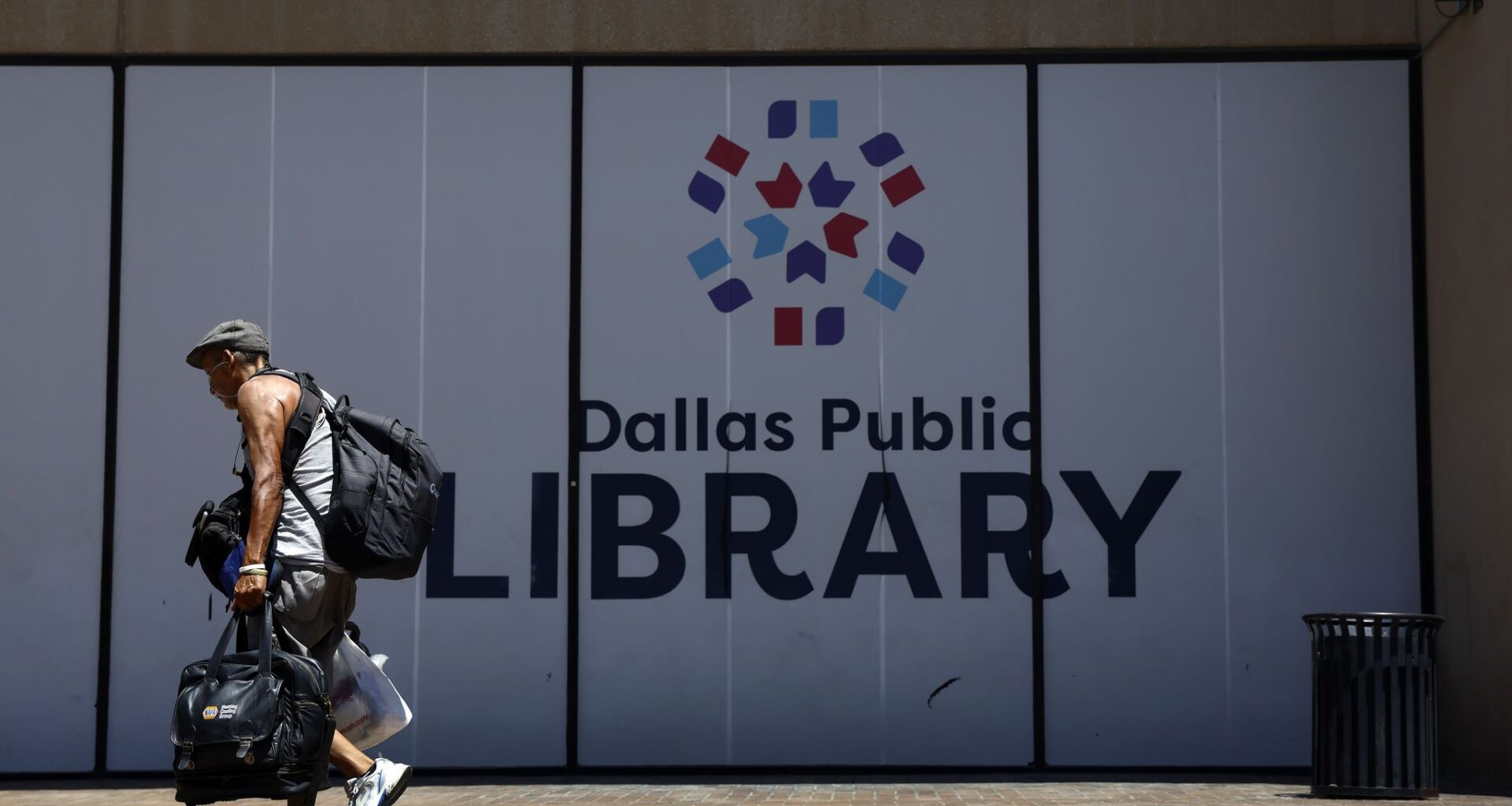 A man heads for the front door of the closed J. Erik Jonsson Central Library, July 10, 2026, after the city decided to furlough employees to save money. He found the doors locked and a sign informing him of the furlough.