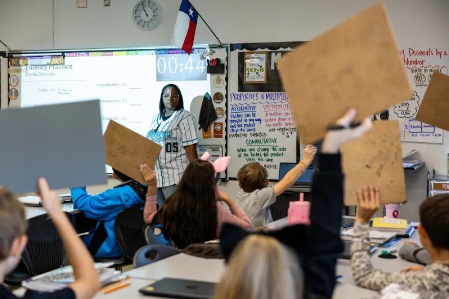East Central ISD teacher DeAndria Wilson works through math problems with her fifth grade class at Tradition Elementary School on Oct. 31, 2025.