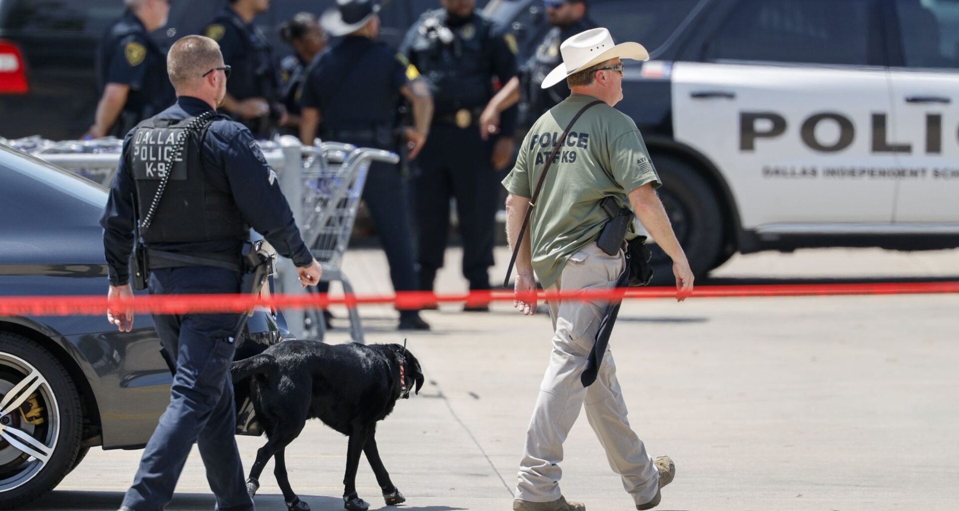 A Dallas police officer and an ATF agent work the scene after a Dallas ISD police officer was shot and wounded in the parking lot of a Sam's Club in northwest Dallas on Thursday, Aug. 6, 2026.