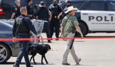 A Dallas police officer and an ATF agent work the scene after a Dallas ISD police officer was shot and wounded in the parking lot of a Sam's Club in northwest Dallas on Thursday, Aug. 6, 2026.