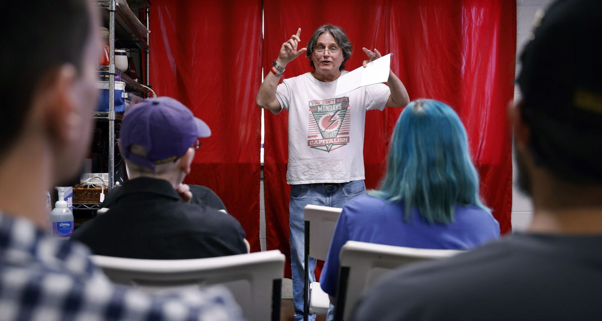 Jo Hargis of the DFW Anti-War Committee (right) listens to a speaker at an event Friday hosted by the Dallas Against the Trump Agenda Coalition, a group plannning a series of protests at the Republican midterm convention in Dallas.