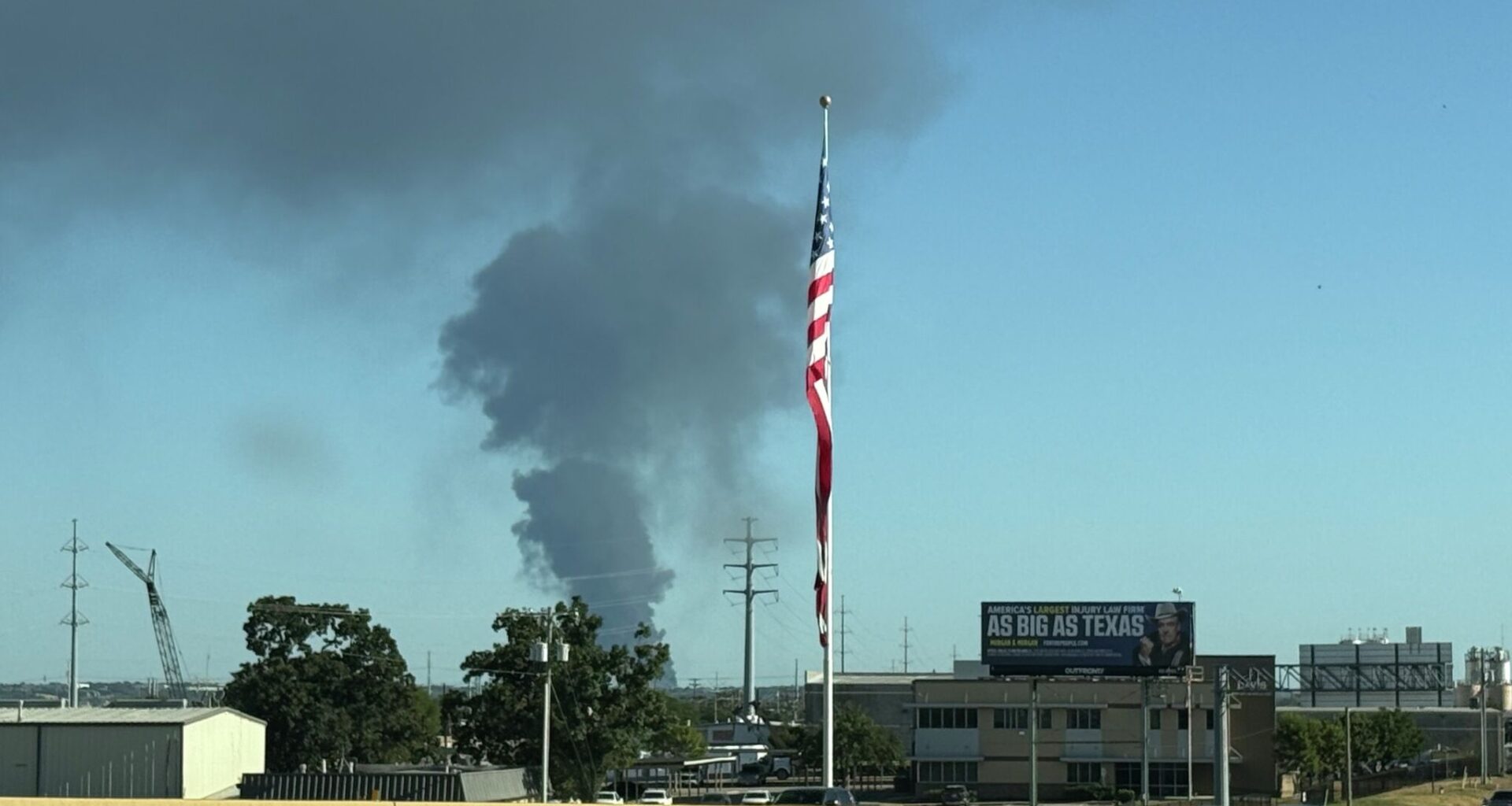 A large smoke plume is seen as a grass fire burns near Dallas' Red Bird and Mountain Creek areas on August 16, 2026.