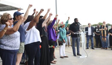 Community members raise their fist remembering Sylvia Collins who lost life in a north Oak Cliff apartment complex fire, Friday, May 29, 2026 in Dallas.