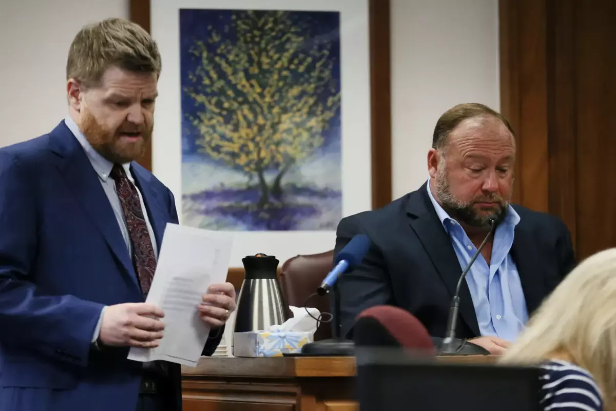 Mark Bankston, lawyer for Neil Heslin and Scarlett Lewis, asks Alex Jones questions about text messages during the trial at the Travis County courthouse in 2022.
