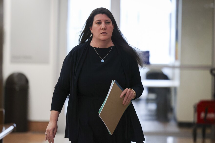 Guardian ad litem Susan Duesler walks out of the courtroom after a hearing regarding a temporary restraining order Tuesday, Aug. 25, 2026, in Dallas.