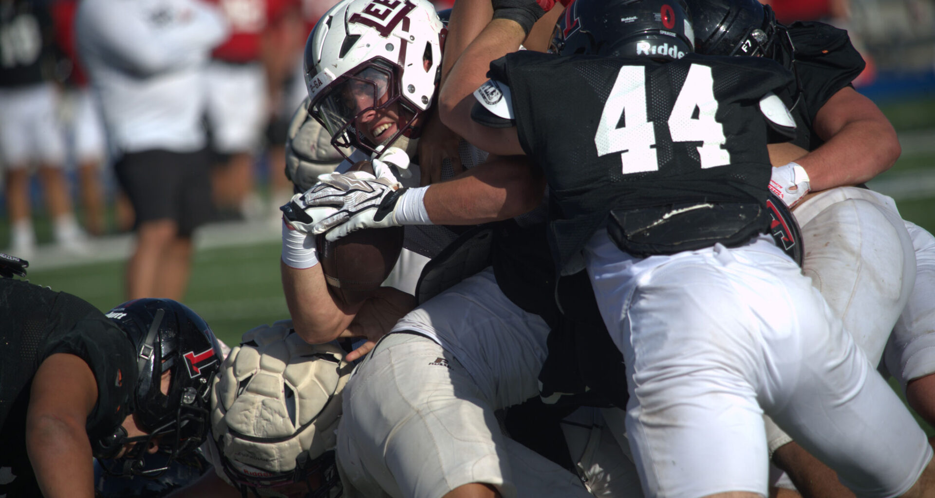 Midland Lee running back Hayes Hamm tries to power through the Amarillo Tascosa defense on a goal line carry during a scrimmage, Aug. 14, 2026, at Astound Broadband Stadium. 