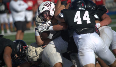 Midland Lee running back Hayes Hamm tries to power through the Amarillo Tascosa defense on a goal line carry during a scrimmage, Aug. 14, 2026, at Astound Broadband Stadium. 